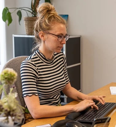 Woman Software Developer working at the Alter Solutions office